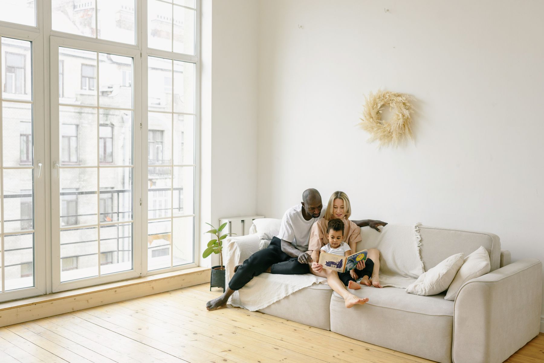 Multiracial family relaxing together on a couch at home